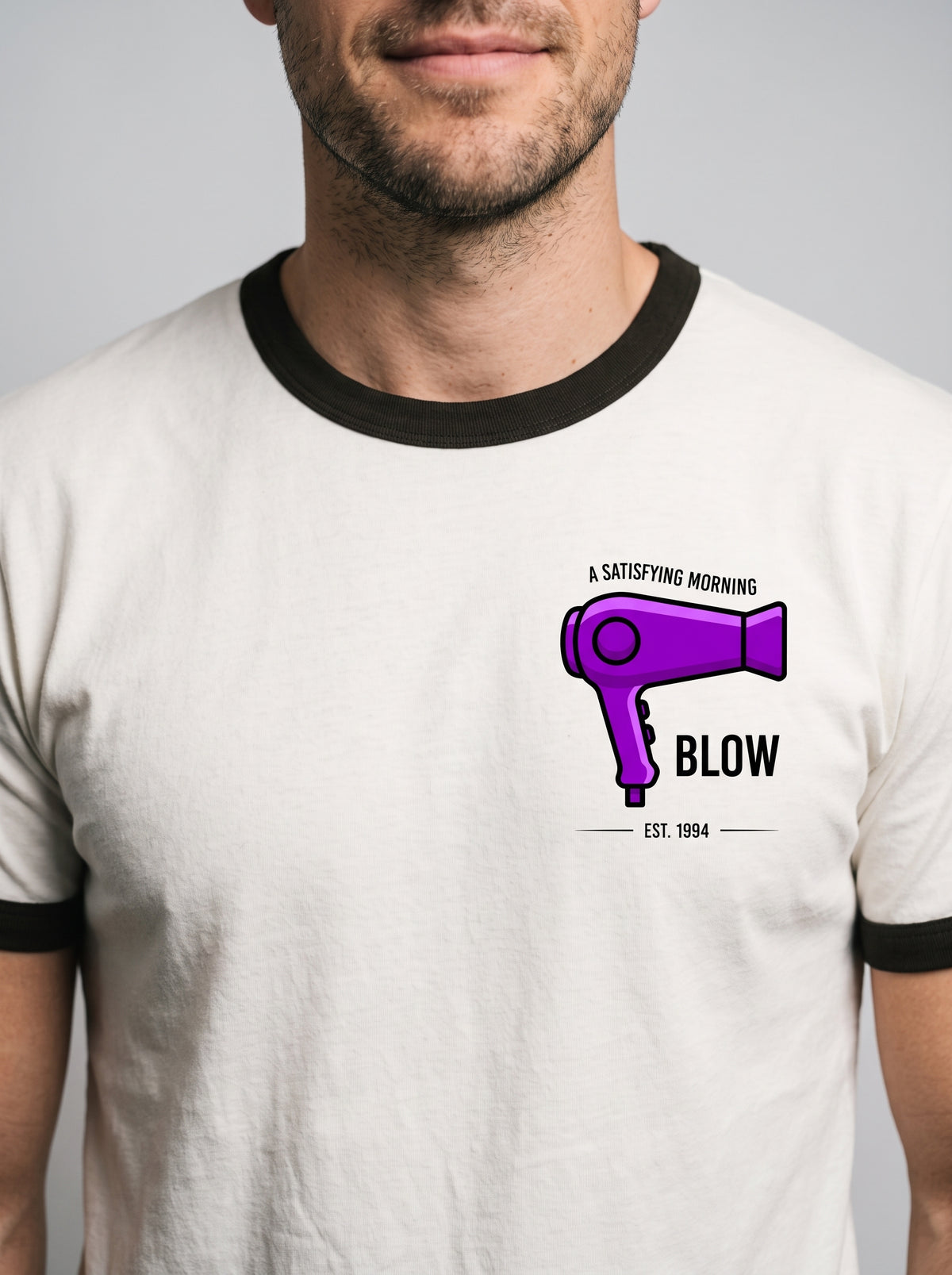 Close-up of the A Morning Blow hair dryer print on the left chest of the ringer t-shirt